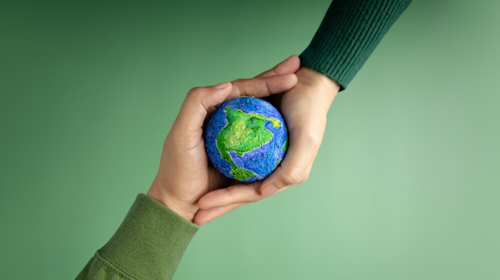 two hands holding a mini globe